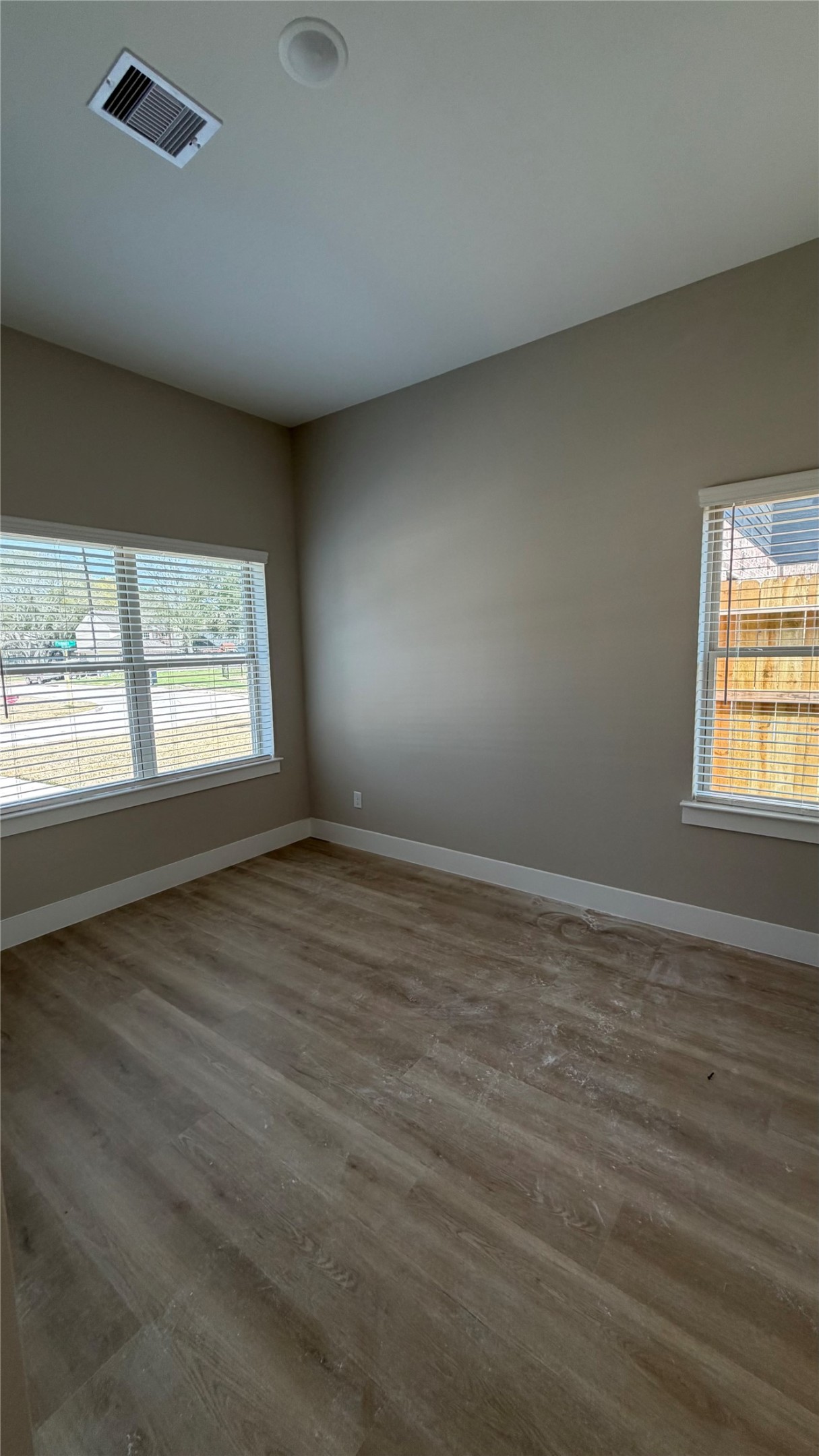 2607 Piemonte Avenue Cir Spring Spring, TX 77388 - Photo 13 of 38 an empty room with wooden floor and windows