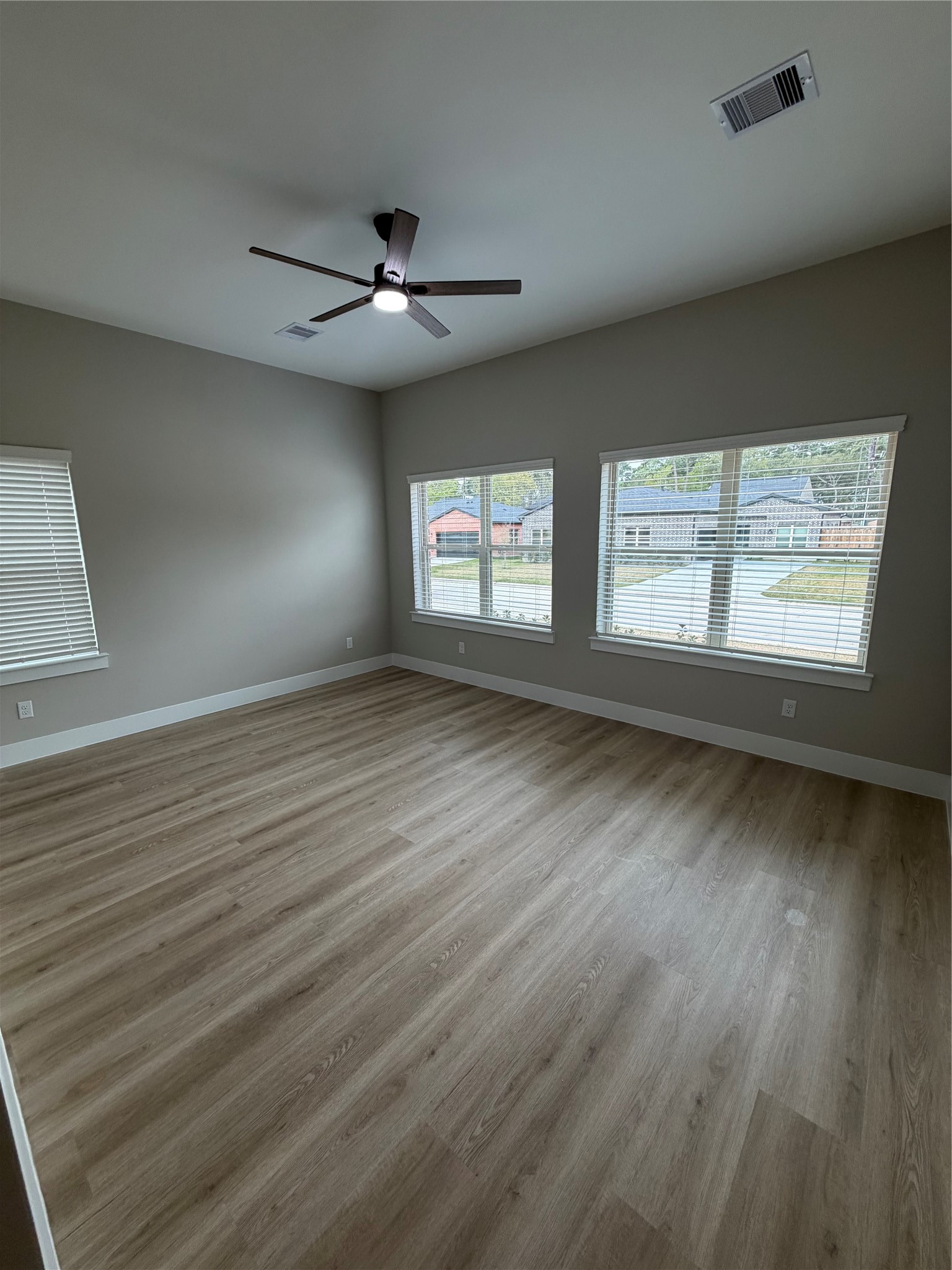 2607 Piemonte Avenue Cir Spring Spring, TX 77388 - Photo 21 of 38 an empty room with wooden floor and windows