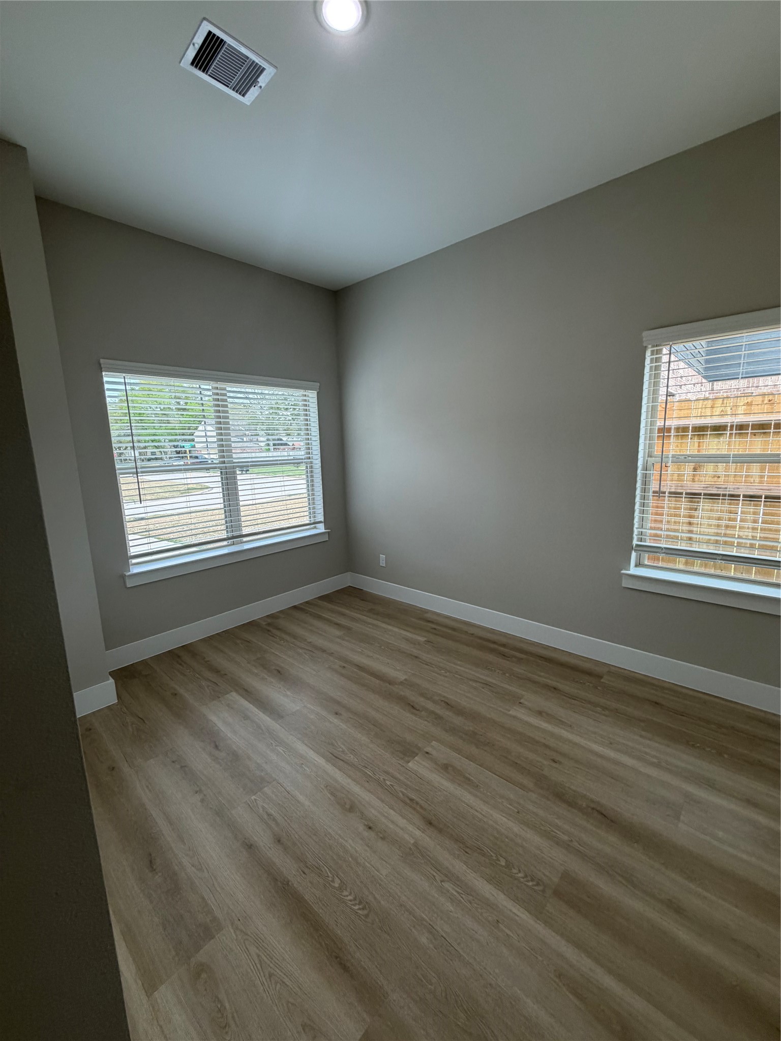 2607 Piemonte Avenue Cir Spring Spring, TX 77388 - Photo 31 of 38 an empty room with wooden floor and windows