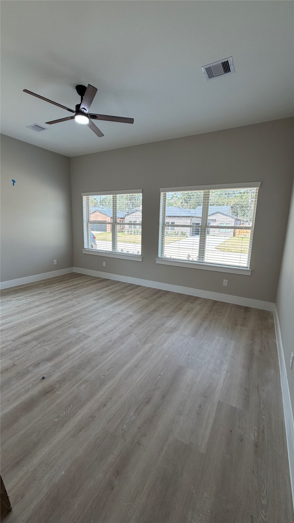2607 Piemonte Avenue Cir Spring Spring, TX 77388 - Photo 8 of 38 an empty room with wooden floor and windows