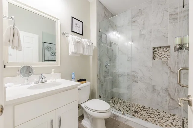 a bathroom with a sink toilet and shower