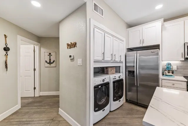 a kitchen with stainless steel appliances a refrigerator a stove and cabinets