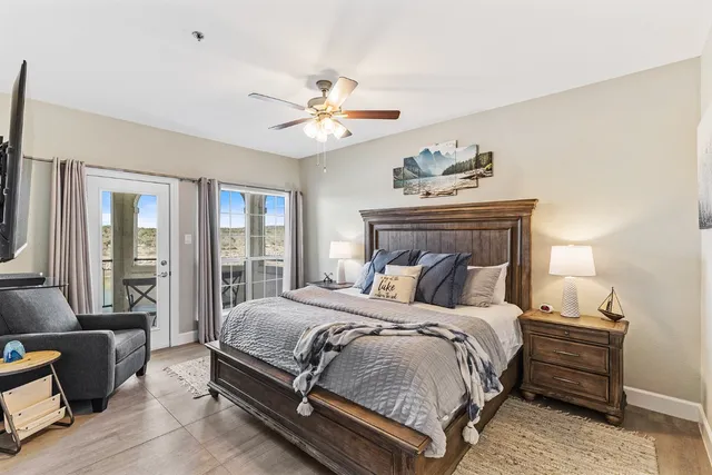 a bedroom with a large bed and a chandelier
