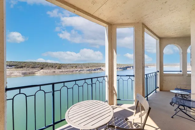 a view of a balcony with chair and table