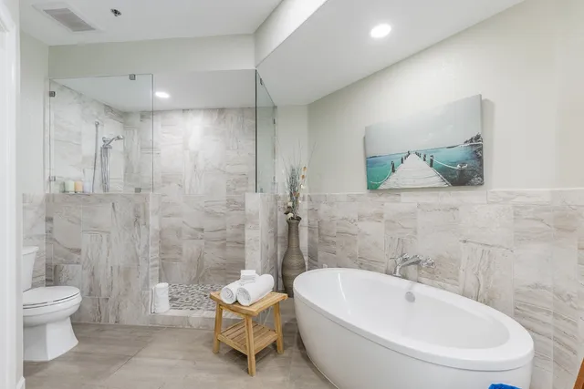 a bathroom with a toilet sink and shower