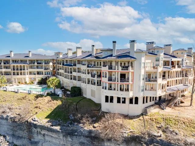 a large building with a large pool in front of it