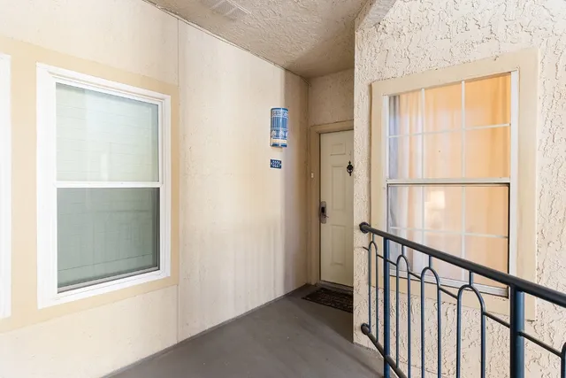 a view of a building with backyard and sitting area
