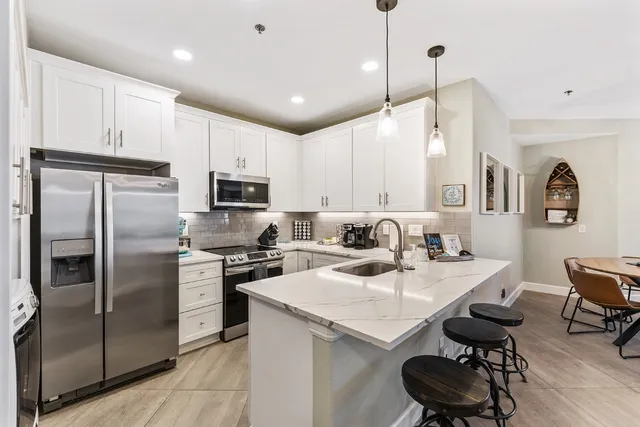 a kitchen with a sink stainless steel appliances and cabinets