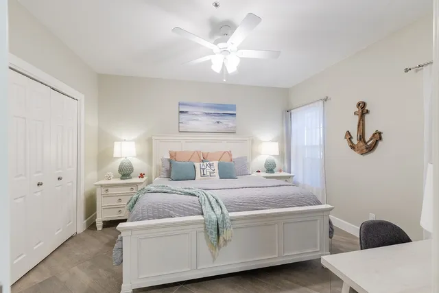 a bedroom with a large bed and a chandelier