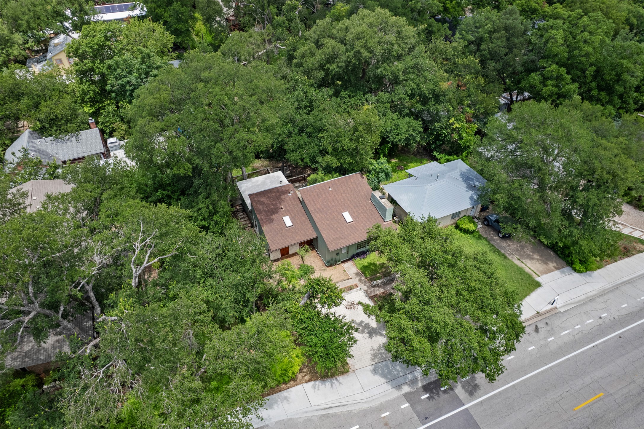 3302 Cherrywood Road Austin, TX 78722 - Photo 23 of 26 An aerial perspective reveals a private home nestled amidst a verdant, mature treeline.