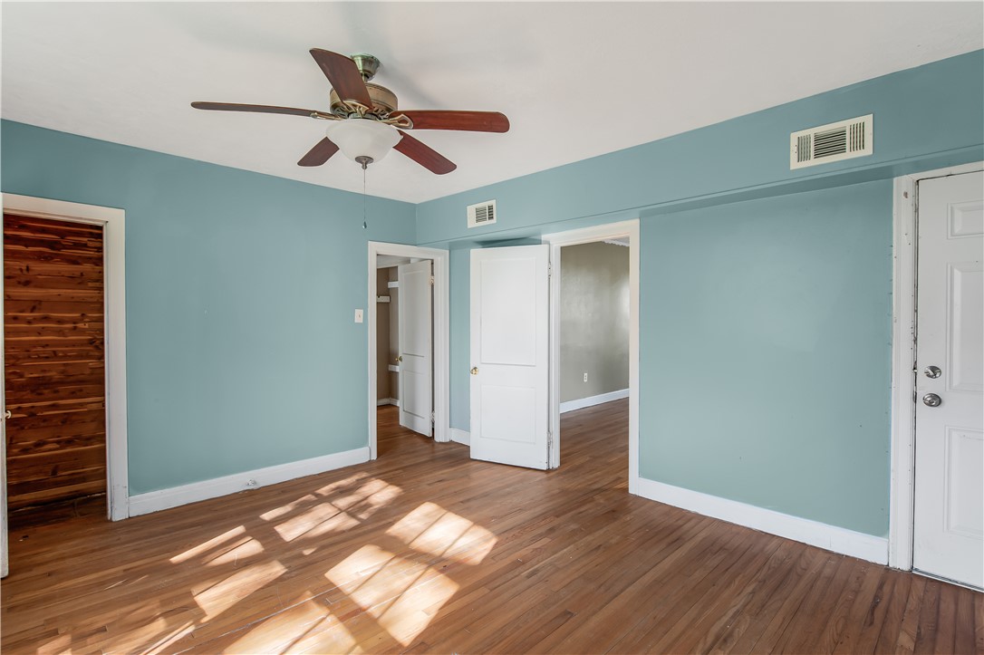 1207 East 27th Street Bryan, TX 77803 - Photo 13 of 23 wooden floor in an empty room with a window