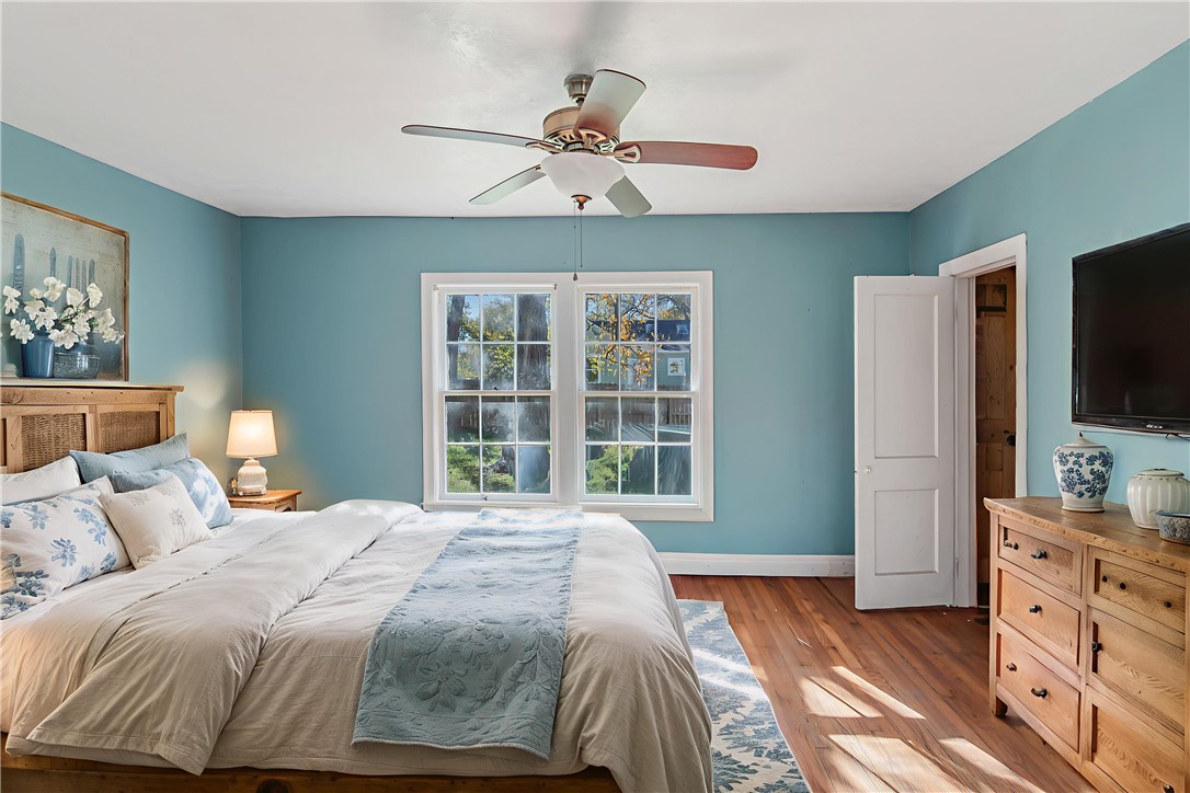 1207 East 27th Street Bryan, TX 77803 - Photo 3 of 23 a bedroom with a large bed and a flat tv screen on dresser