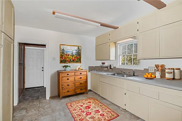 a kitchen with a sink and cabinets