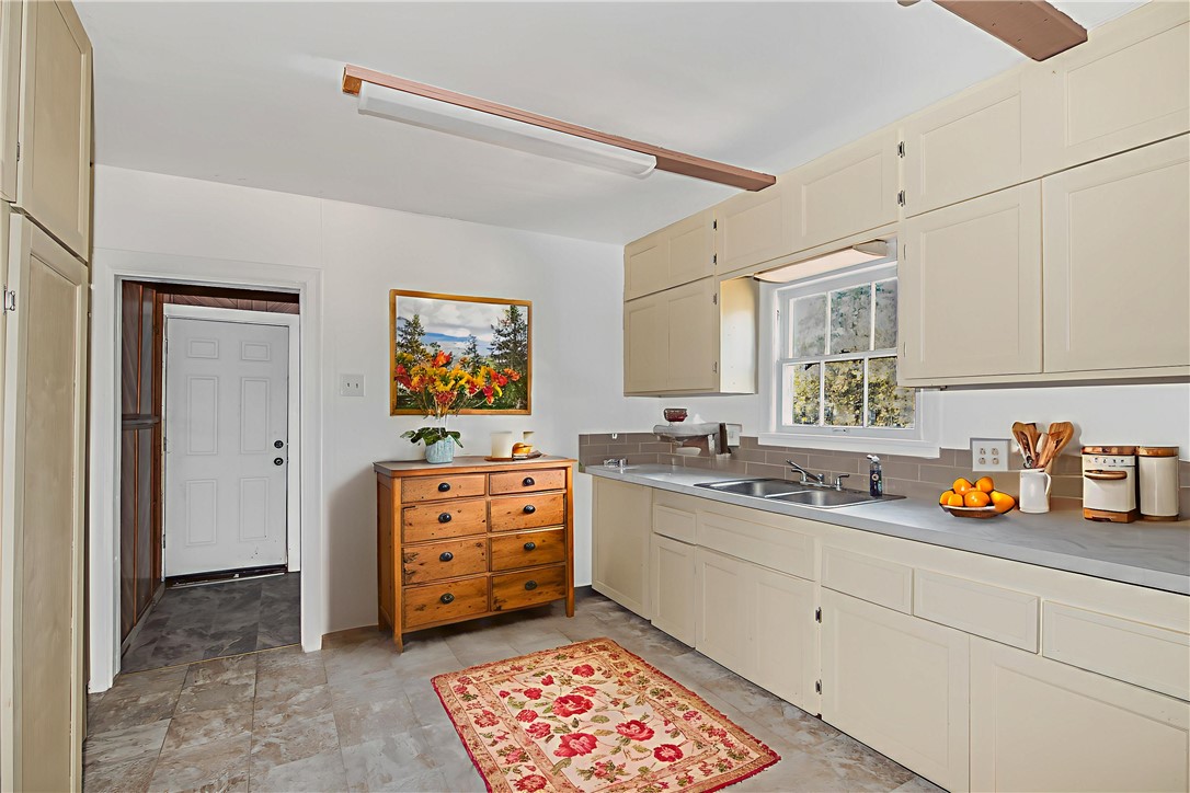 1207 East 27th Street Bryan, TX 77803 - Photo 6 of 23 a kitchen with a sink and cabinets