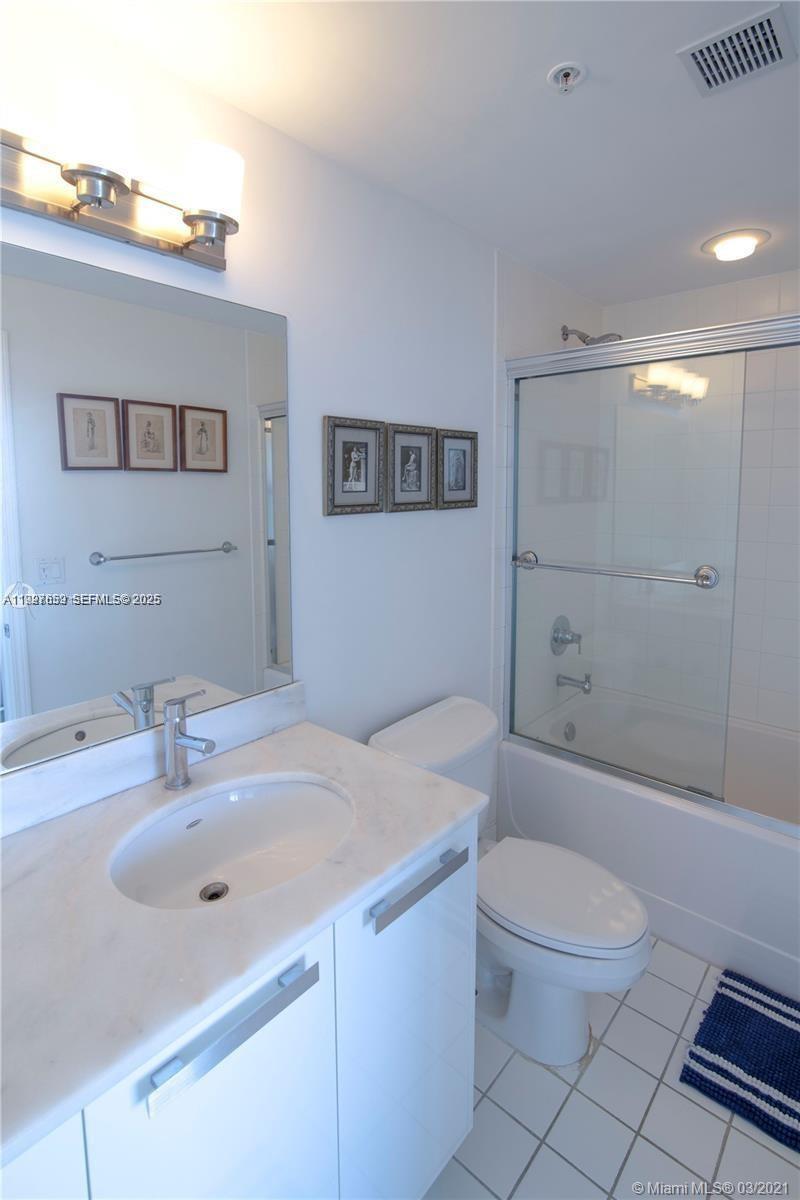 601 Northeast 36th Street, Unit 3101 Miami, FL 33137 - Photo 15 of 25 a bathroom with a sink a toilet and shower