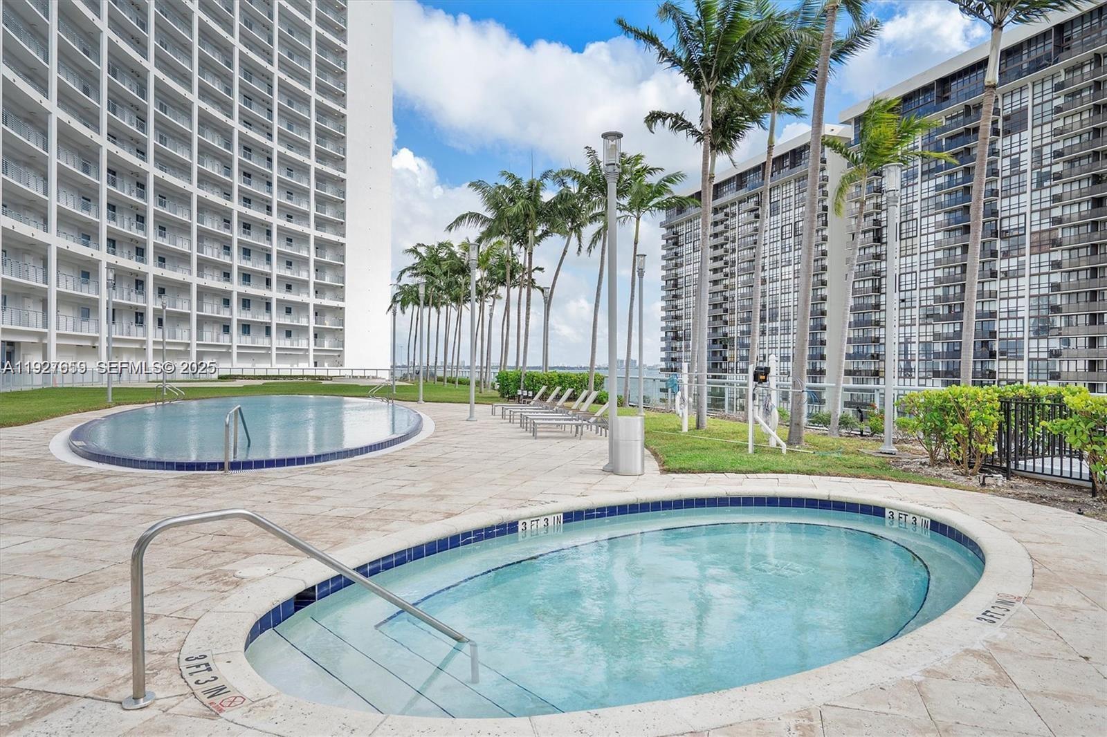 601 Northeast 36th Street, Unit 3101 Miami, FL 33137 - Photo 19 of 25 a view of a swimming pool with a patio
