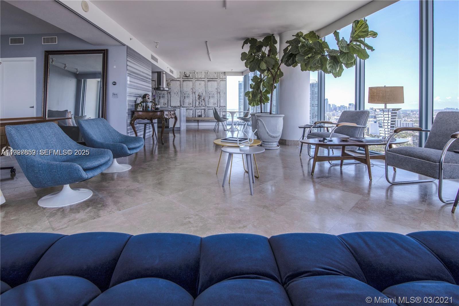 601 Northeast 36th Street, Unit 3101 Miami, FL 33137 - Photo 2 of 25 a living room with furniture and a large window