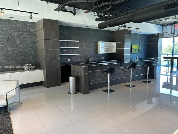 a kitchen with a sink a counter and appliances