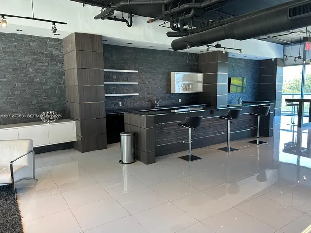 a kitchen with a sink a counter and appliances