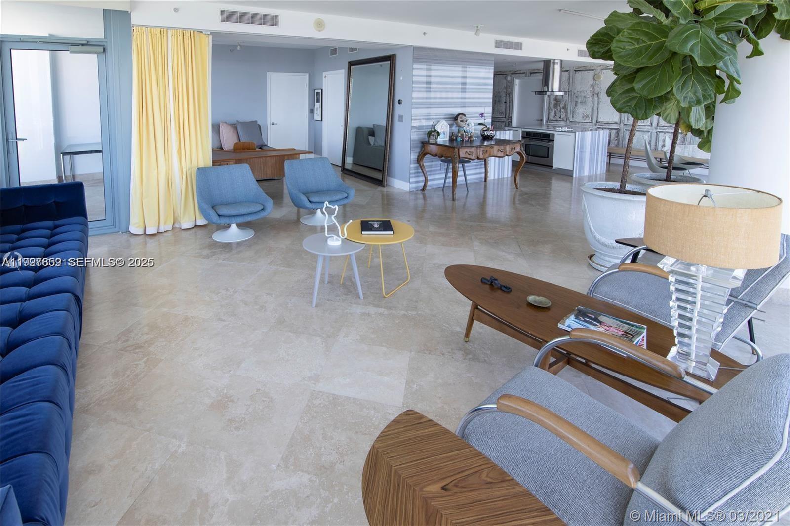 601 Northeast 36th Street, Unit 3101 Miami, FL 33137 - Photo 3 of 25 a living room with furniture gym equipment and large windows