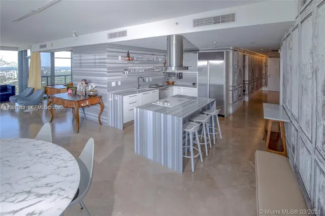 an open kitchen with a table and chairs