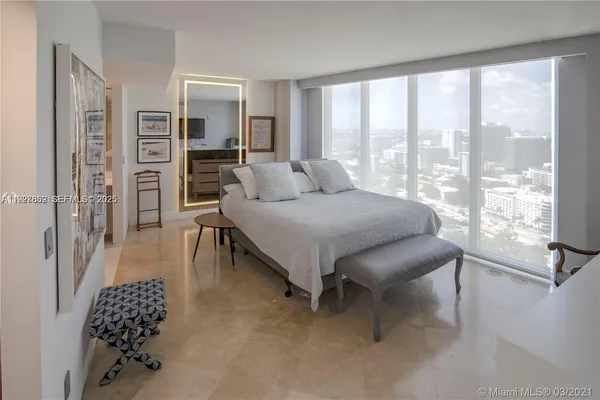 a living room with furniture and a floor to ceiling window