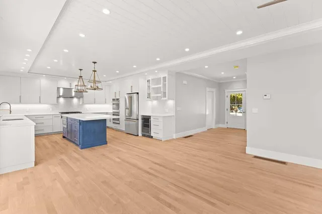 a large kitchen with stainless steel appliances kitchen island a large counter top and a view of kitchen