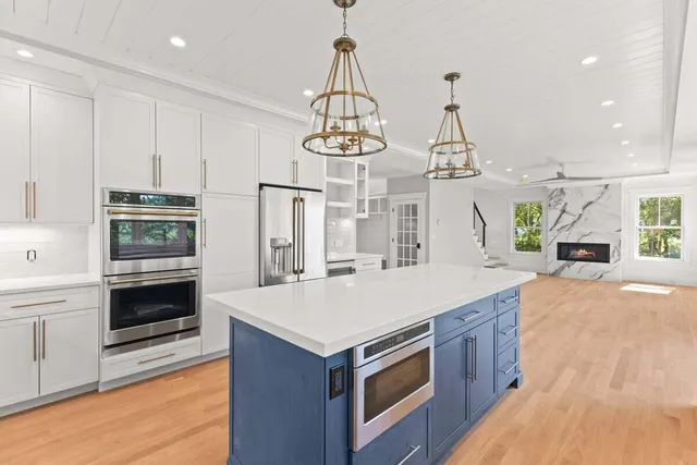 a kitchen with a stove a sink and a refrigerator