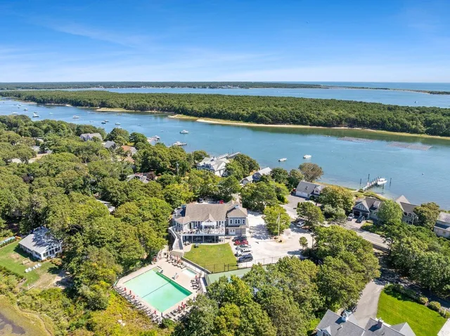 a view of a roof deck with table and chairs with wooden floor and fence