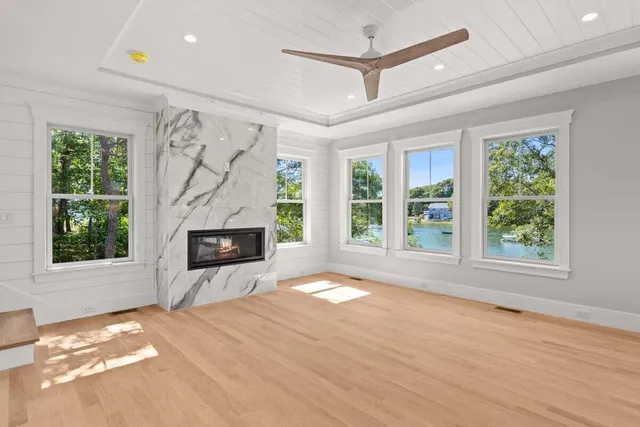 a view of an empty room with a fireplace and a window