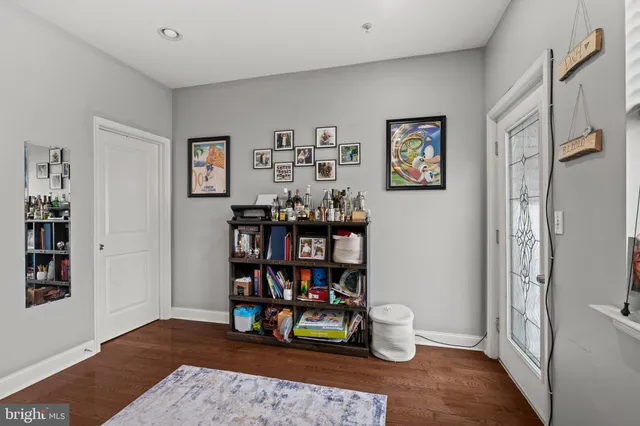 a room with lots of books and a painting on the wall