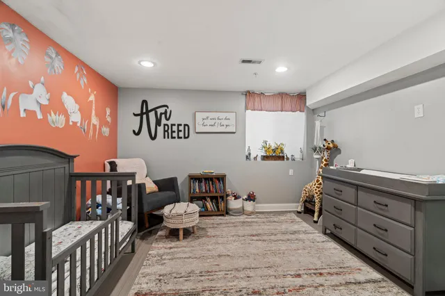 a bed room with furniture and a baby crib