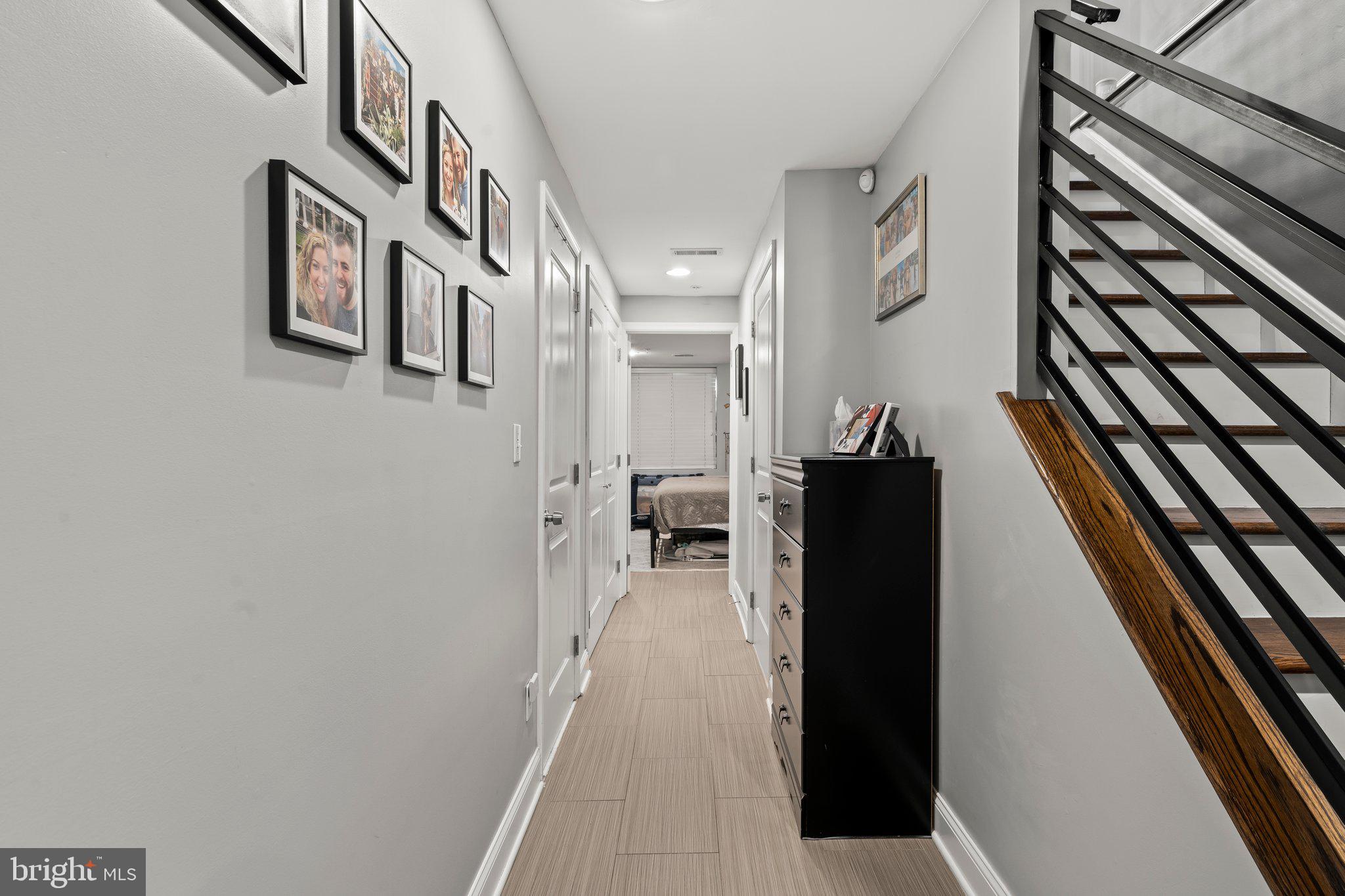 2115 Carpenter Street, Unit 1 Philadelphia, PA 19146 - Photo 19 of 24 a view of a hallway with wooden floor and staircase