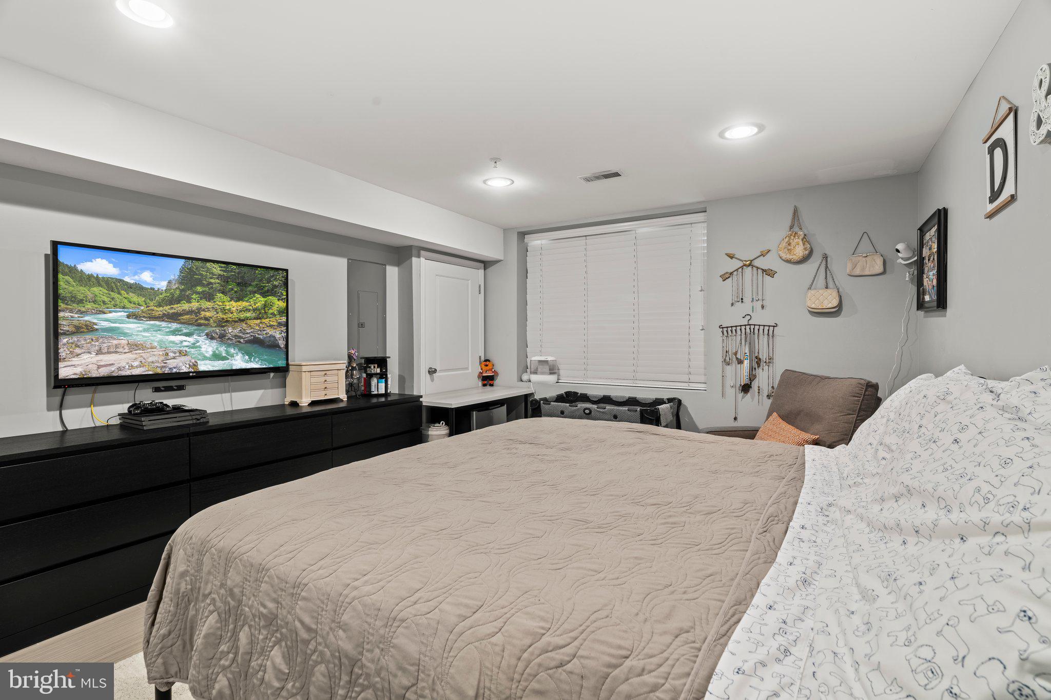 2115 Carpenter Street, Unit 1 Philadelphia, PA 19146 - Photo 21 of 24 a bedroom with a bed and a flat screen tv