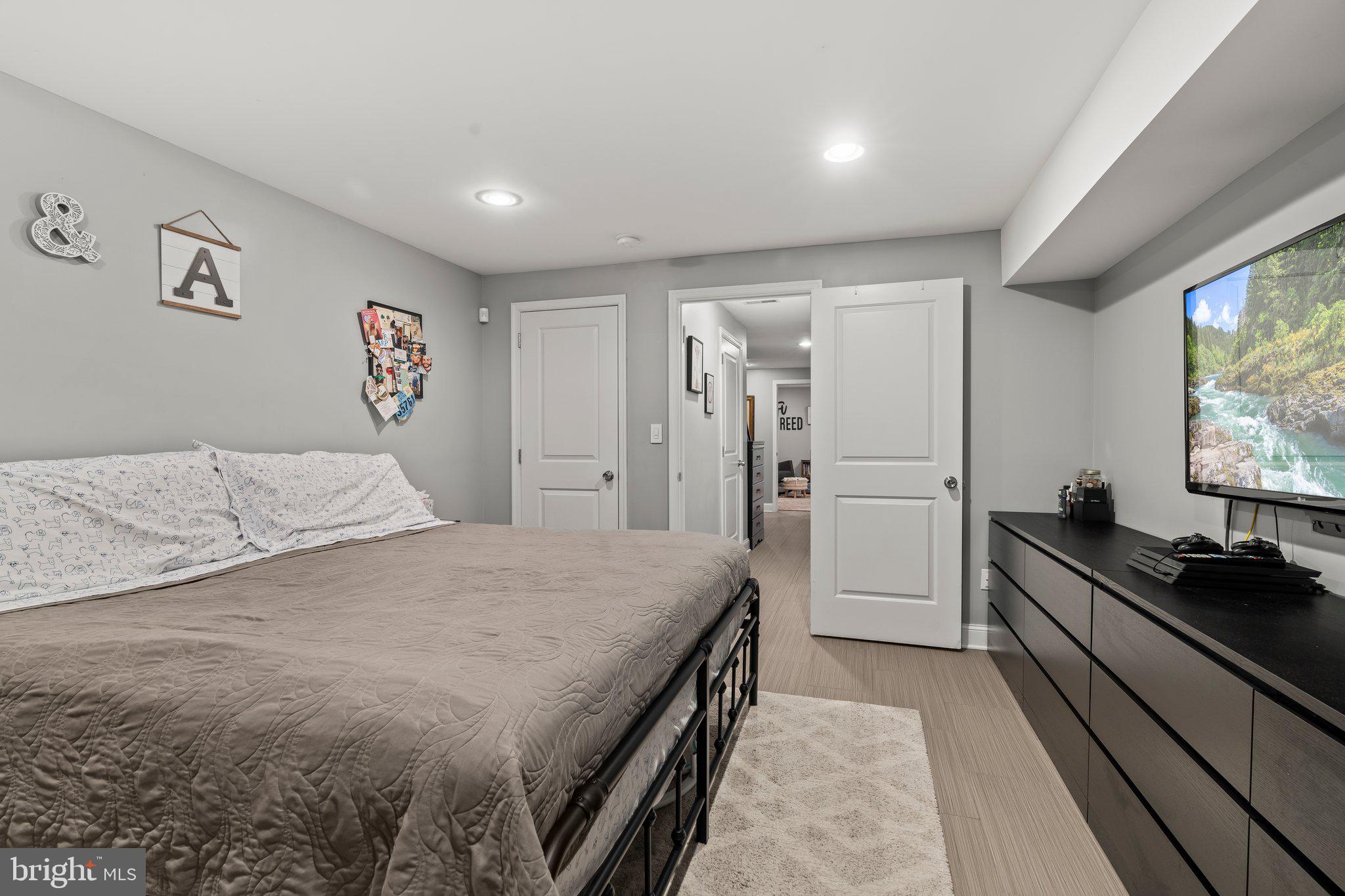 2115 Carpenter Street, Unit 1 Philadelphia, PA 19146 - Photo 22 of 24 a spacious bedroom with a bed and a flat screen tv