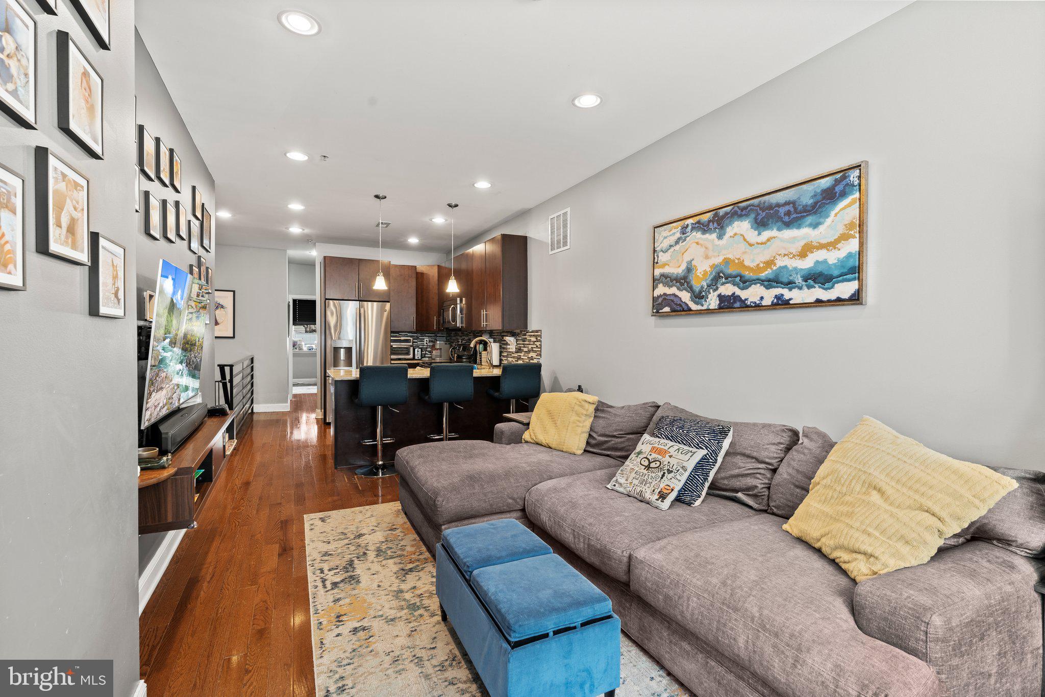 2115 Carpenter Street, Unit 1 Philadelphia, PA 19146 - Photo 4 of 24 a living room with furniture and a flat screen tv