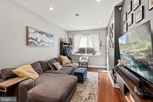 a living room with furniture and a floor to ceiling window