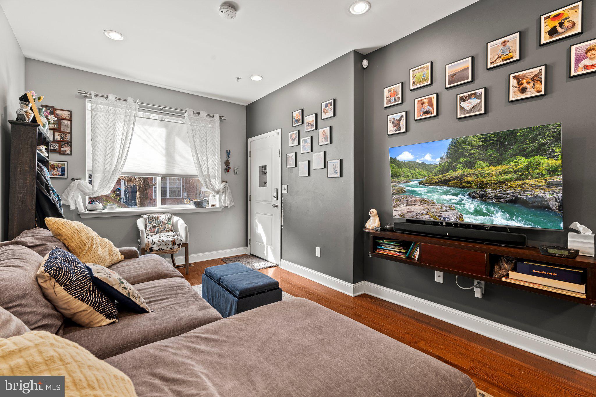 2115 Carpenter Street, Unit 1 Philadelphia, PA 19146 - Photo 6 of 24 a living room with furniture and a flat screen tv