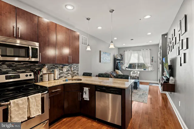 a kitchen with a stove sink and cabinets