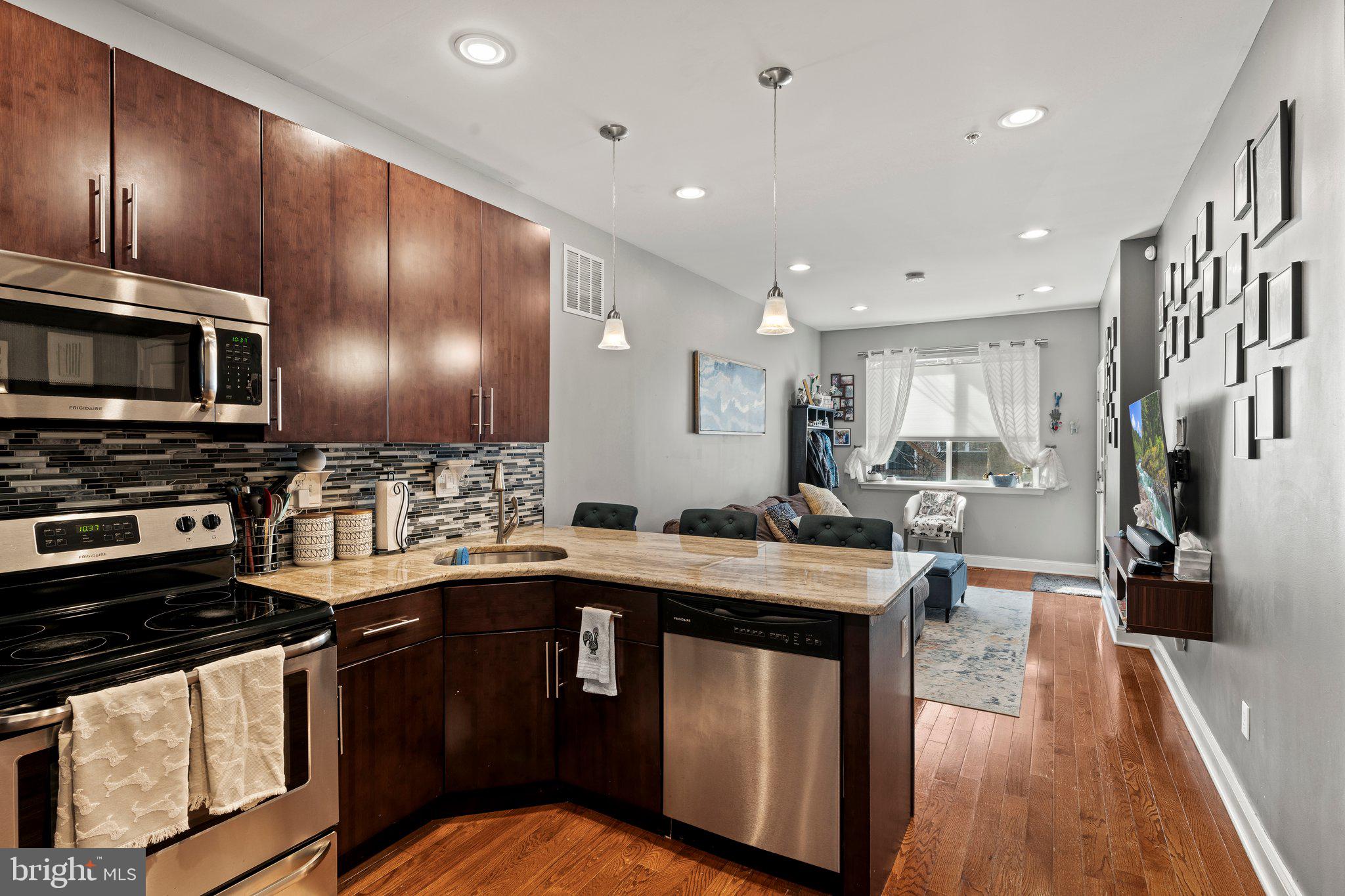 2115 Carpenter Street, Unit 1 Philadelphia, PA 19146 - Photo 10 of 24 a kitchen with a stove sink and cabinets