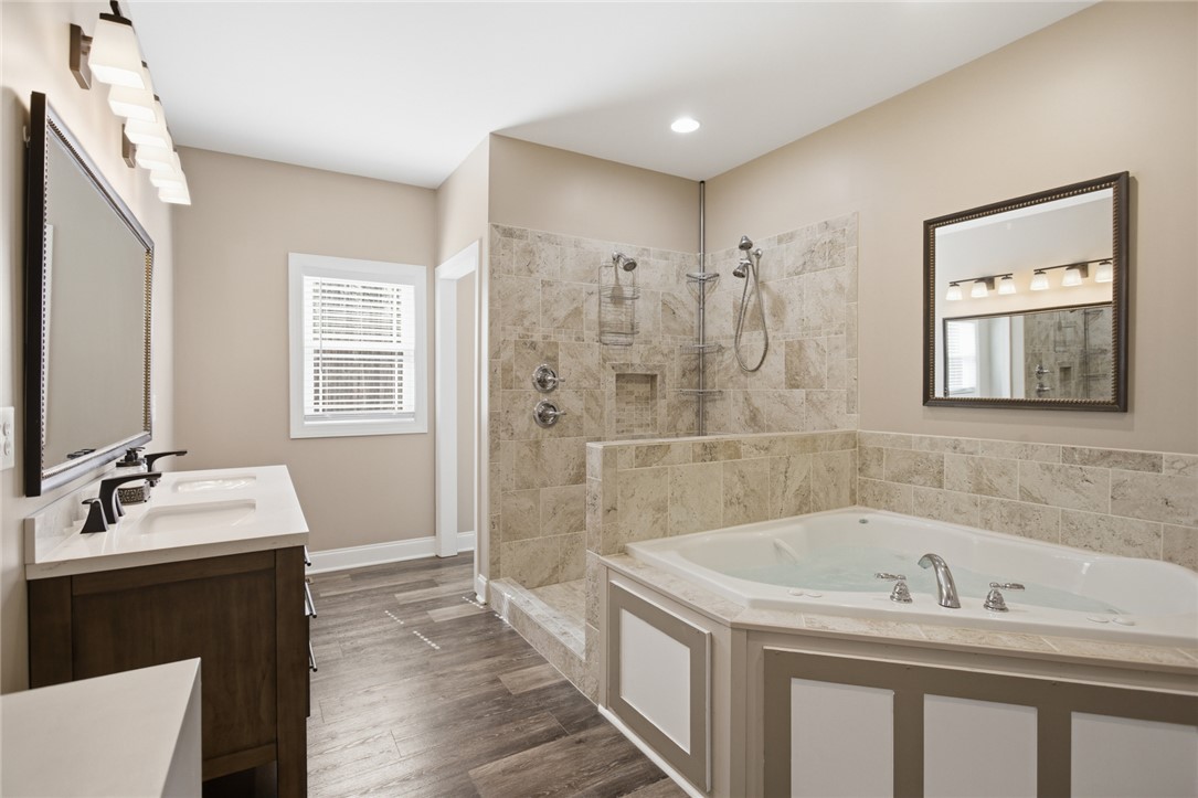 196 Flyroot Trail Pickens, SC 29671 - Photo 19 of 48 This bathroom features a deep soaking tub and a spacious shower, ideal for daily refreshment.