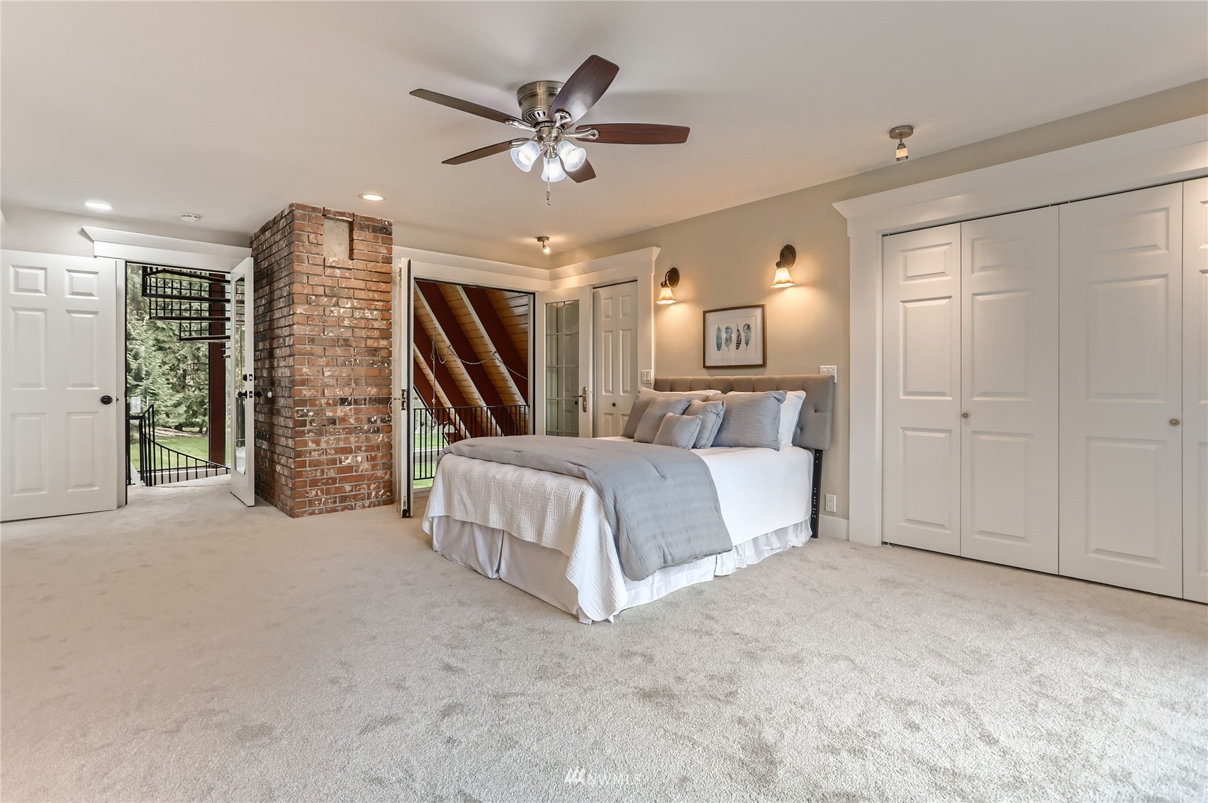 19810 43rd Avenue Southeast Bothell, WA 98012 - Photo 15 of 40 a spacious bedroom with a bed a ceiling fan and a walk in closet