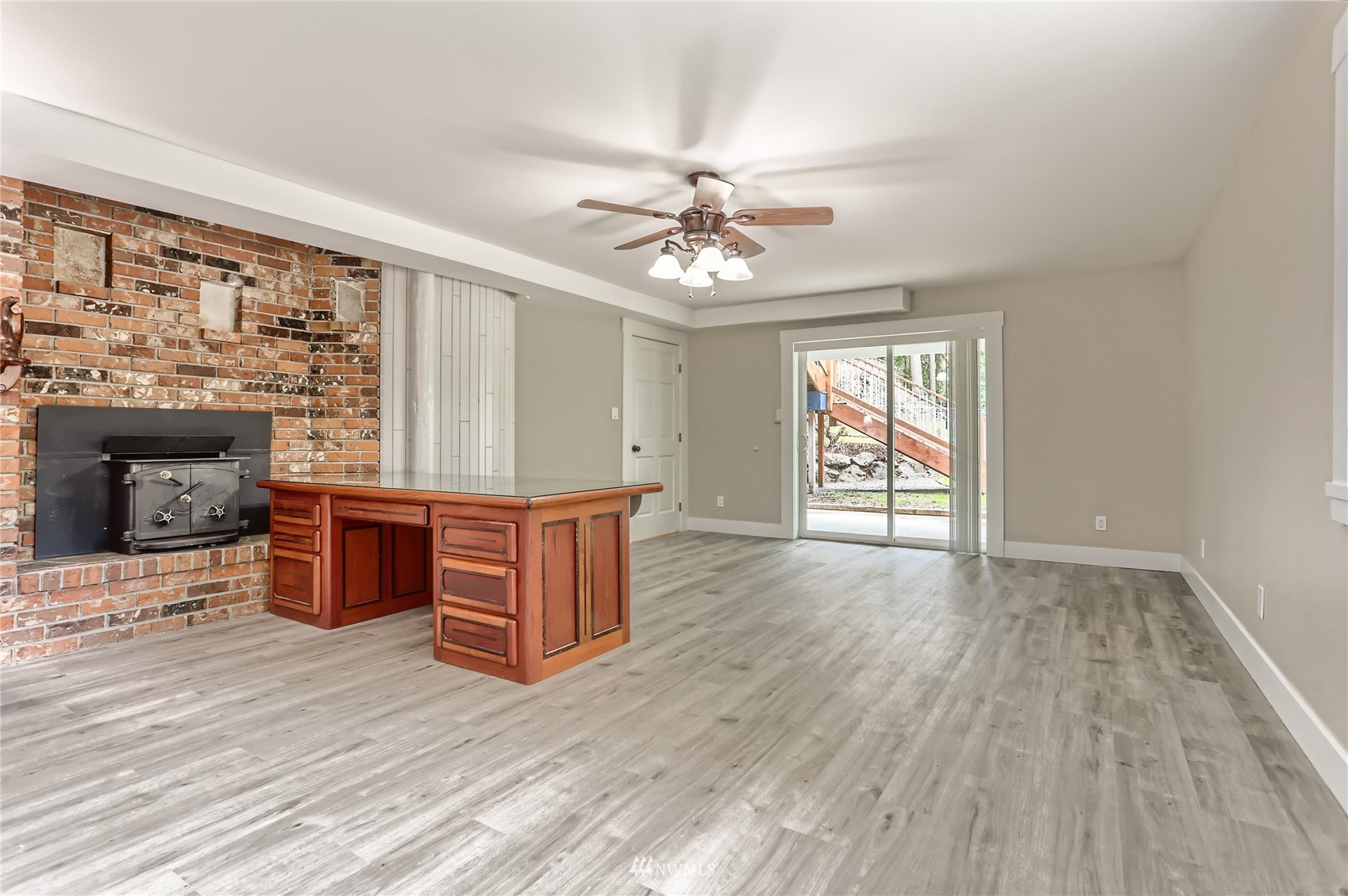 19810 43rd Avenue Southeast Bothell, WA 98012 - Photo 26 of 40 wooden floor fireplace and windows in an empty room