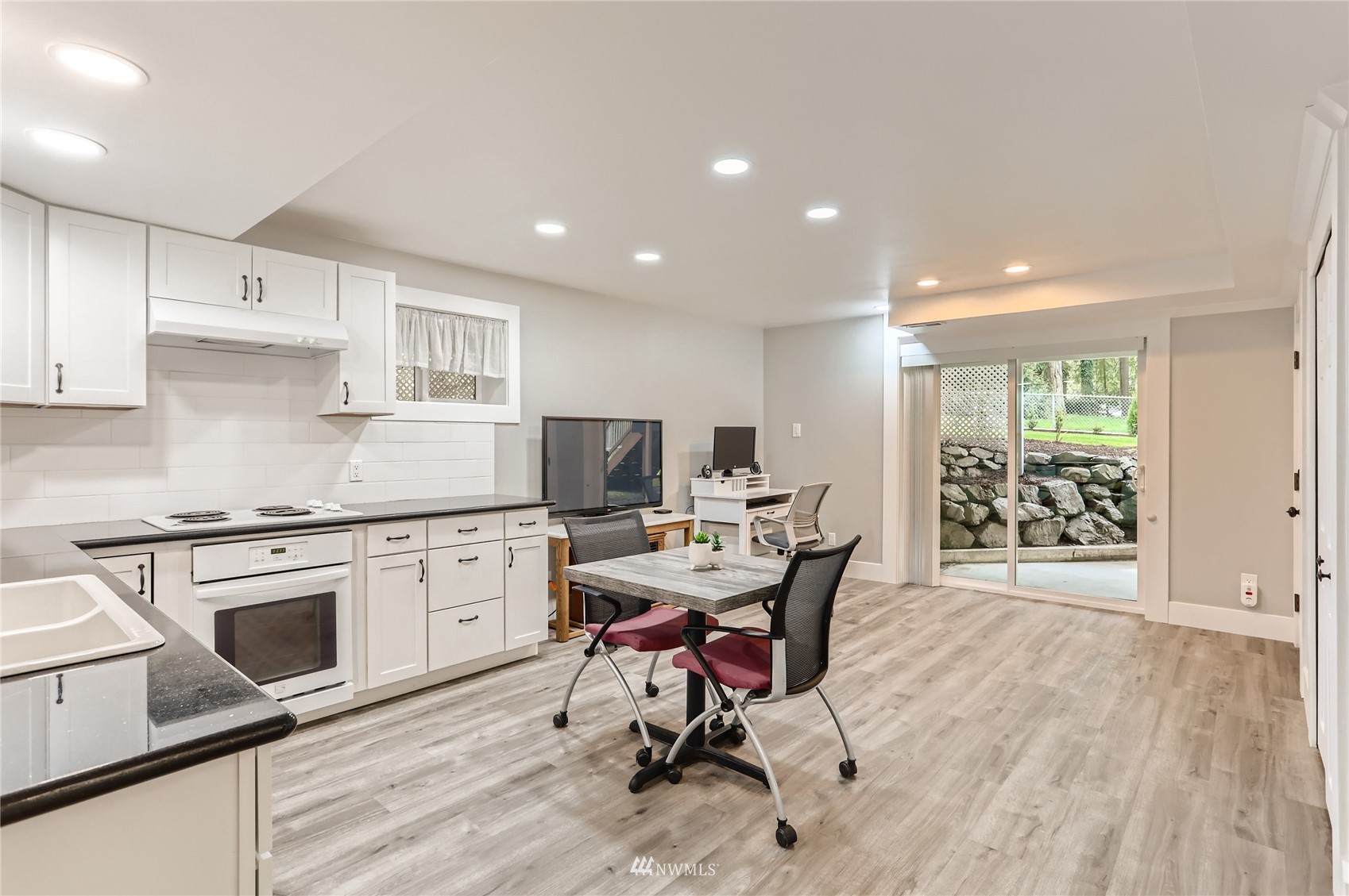 19810 43rd Avenue Southeast Bothell, WA 98012 - Photo 28 of 40 a view of a kitchen with workspace and wooden floor
