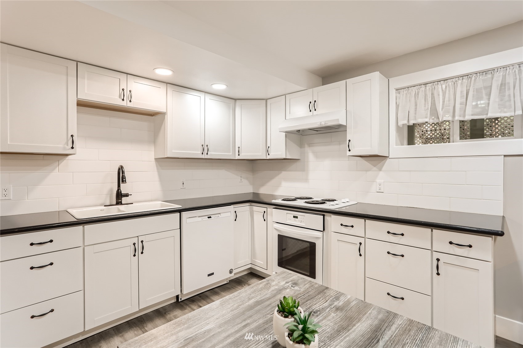 19810 43rd Avenue Southeast Bothell, WA 98012 - Photo 29 of 40 a kitchen with white cabinets white stainless steel appliances and sink