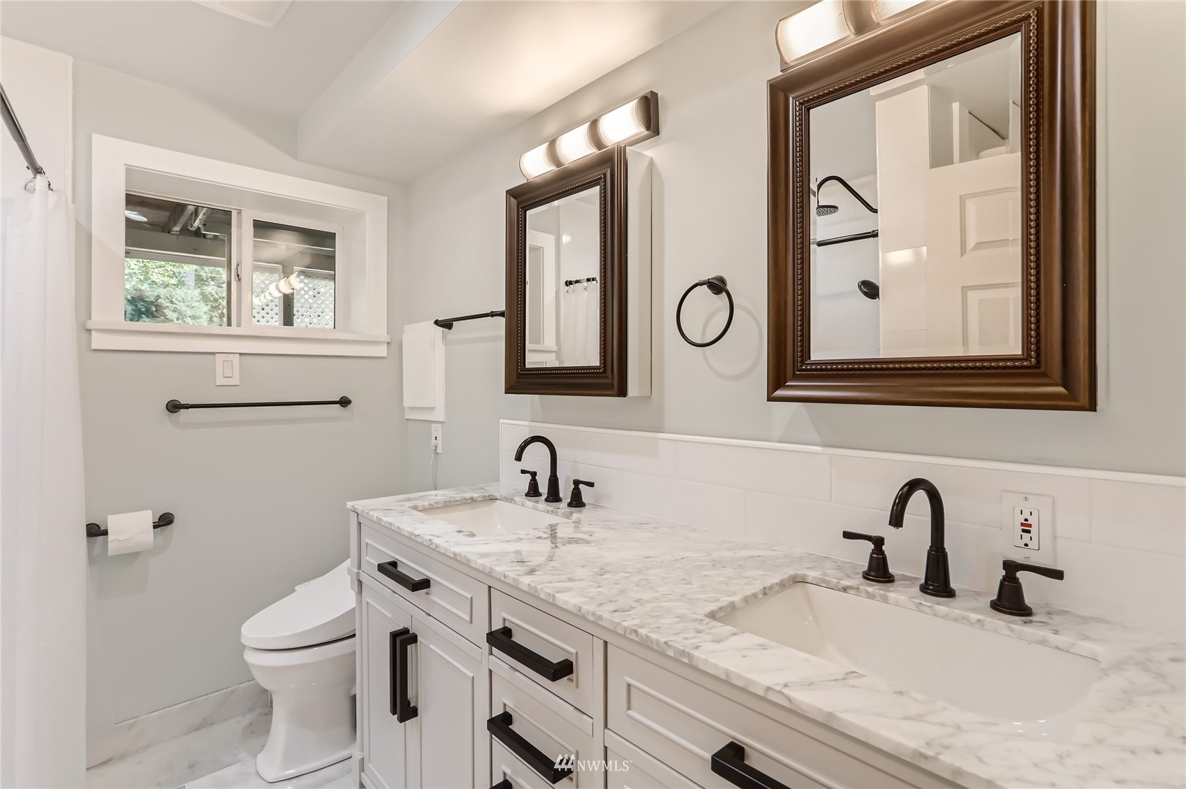 19810 43rd Avenue Southeast Bothell, WA 98012 - Photo 31 of 40 a bathroom with a granite countertop toilet sink and mirror