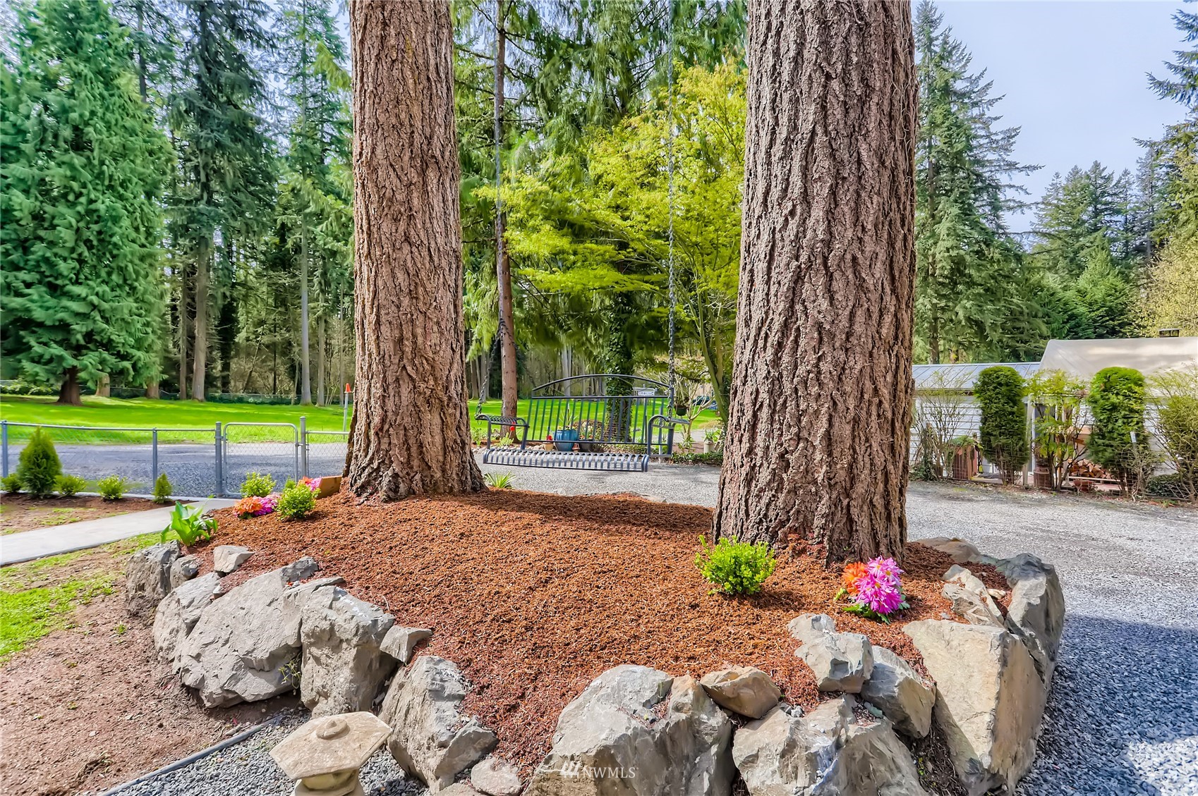 19810 43rd Avenue Southeast Bothell, WA 98012 - Photo 40 of 40 a wooden bench sitting in the middle of a park