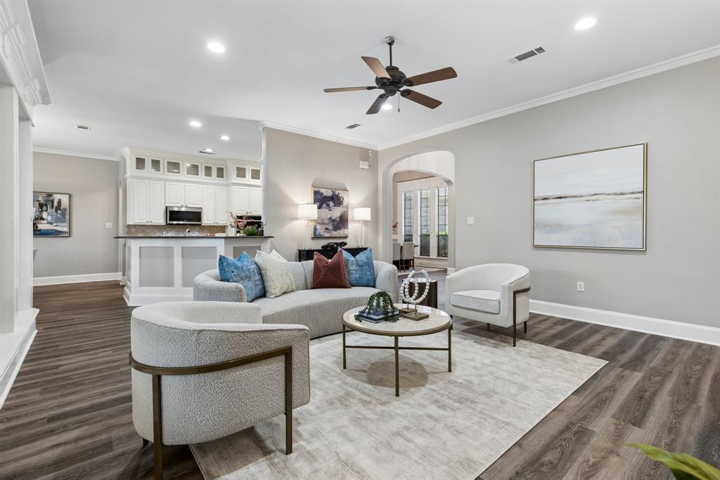 317 Singing Quail Trail Haslet, TX 76052 - Photo 7 of 32 Living area featuring wood-finish flooring, light gray walls, and crown molding