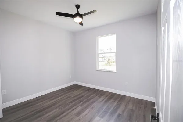 a view of a room with wooden floor