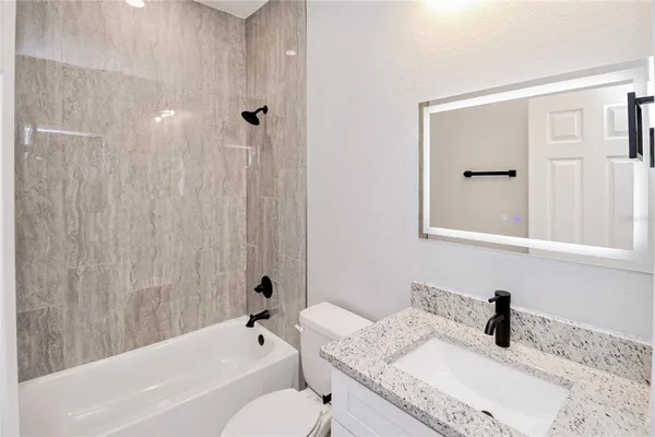 a bathroom with a bathtub and shower